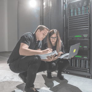 IT Engineering Staffing & Recruiting image of man and woman working together on computer servers