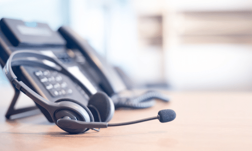 National VP of Customer Support Firm - customer service headset and phone on a desk at a tech company